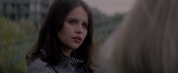 Movie still from “The Last Letter from Your Lover” (2021), directed by Augustine Frizzell – A person wearing a jacket; Close Up shot, Over the shoulder angle