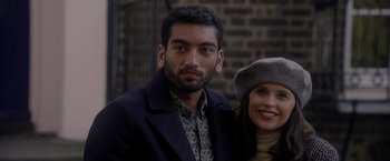 Movie still from “The Last Letter from Your Lover” (2021), directed by Augustine Frizzell – A man and a woman posing for a picture; Close Up shot, Over the shoulder angle