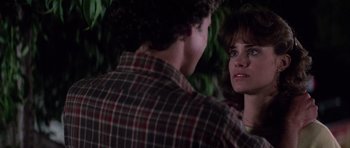 Movie still from “The Last Starfighter” (1984), directed by Nick Castle – A man and a woman standing next to each other; Close Up shot, Over the shoulder angle