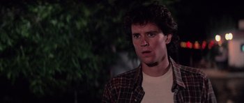 Movie still from “The Last Starfighter” (1984), directed by Nick Castle – A man in a plaid shirt is looking at the camera; Close Up shot, Low angle