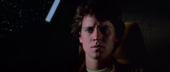 Movie still from “The Last Starfighter” (1984), directed by Nick Castle – A young man is looking into the camera; Close Up shot, Low angle