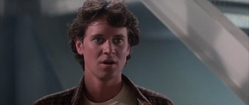 Movie still from “The Last Starfighter” (1984), directed by Nick Castle – A person wearing a plaid shirt; Close Up shot, Low angle