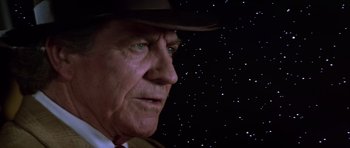 Movie still from “The Last Starfighter” (1984), directed by Nick Castle – An older man wearing a hat looking at the stars; Close Up shot, Low angle