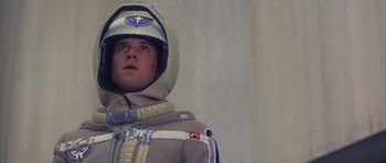 Movie still from “The Last Starfighter” (1984), directed by Nick Castle – A man wearing a space suit and helmet; Close Up shot, Low angle