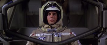 Movie still from “The Last Starfighter” (1984), directed by Nick Castle – A young man in a space suit is looking at the camera; Close Up shot, Low angle