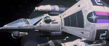 Movie still from “The Last Starfighter” (1984), directed by Nick Castle – View of a space ship in space; Extreme Wide shot, Overhead angle