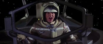 Movie still from “The Last Starfighter” (1984), directed by Nick Castle – A person in a space suit and a helmet; Medium shot, Low angle