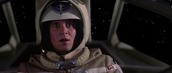 Movie still from “The Last Starfighter” (1984), directed by Nick Castle – A man in a spacesuit and a helmet in a space ship; Close Up shot, Low angle