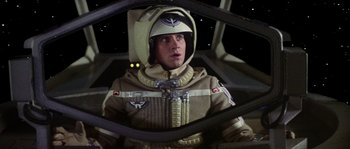 Movie still from “The Last Starfighter” (1984), directed by Nick Castle – A man wearing a space suit and helmet; Medium shot, Low angle