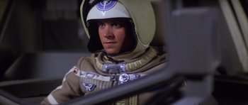 Movie still from “The Last Starfighter” (1984), directed by Nick Castle – A man in a space suit is sitting in a vehicle; Close Up shot, Over the shoulder angle