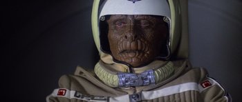 Movie still from “The Last Starfighter” (1984), directed by Nick Castle – The face of a person in a space suit; Close Up shot, Overhead angle