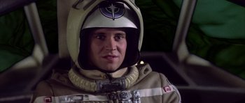 Movie still from “The Last Starfighter” (1984), directed by Nick Castle – A man wearing a space suit and helmet; Close Up shot, Low angle