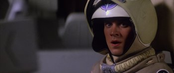 Movie still from “The Last Starfighter” (1984), directed by Nick Castle – A man wearing a helmet and a gas mask; Close Up shot, Over the shoulder angle