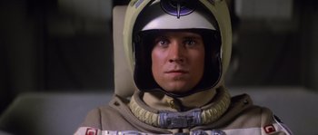 Movie still from “The Last Starfighter” (1984), directed by Nick Castle – A person wearing a helmet; Close Up shot, Low angle