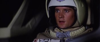 Movie still from “The Last Starfighter” (1984), directed by Nick Castle – A person wearing a helmet; Close Up shot, Low angle
