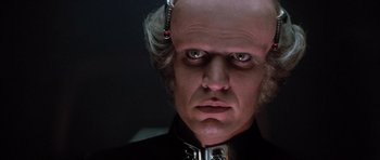 Movie still from “The Last Starfighter” (1984), directed by Nick Castle – A person wearing a costume; Close Up shot, Low angle