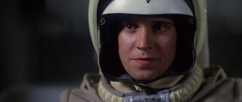Movie still from “The Last Starfighter” (1984), directed by Nick Castle – A person wearing a helmet; Close Up shot, Over the shoulder angle