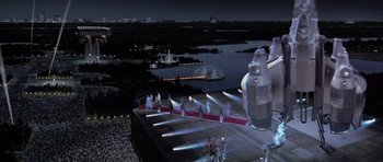 Movie still from “The Last Starfighter” (1984), directed by Nick Castle – An aerial view of a runway with a runway crew standing on it; Extreme Wide shot, High angle