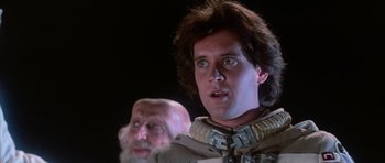 Movie still from “The Last Starfighter” (1984), directed by Nick Castle – A man and an old man are looking at the camera; Close Up shot, Low angle