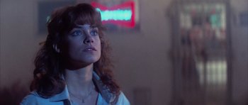 Movie still from “The Last Starfighter” (1984), directed by Nick Castle – A person looking up at a neon sign; Close Up shot, Low angle