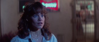 Movie still from “The Last Starfighter” (1984), directed by Nick Castle – A person wearing a white shirt; Close Up shot, Over the shoulder angle