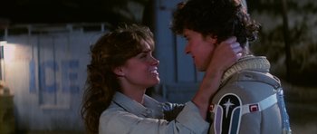 Movie still from “The Last Starfighter” (1984), directed by Nick Castle – A man and a woman touching each other's hair; Close Up shot, Over the shoulder angle