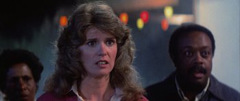 Movie still from “The Last Starfighter” (1984), directed by Nick Castle – A person with long curly hair; Close Up shot, Over the shoulder angle