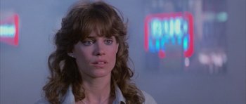 Movie still from “The Last Starfighter” (1984), directed by Nick Castle – A person wearing a white shirt; Close Up shot, Over the shoulder angle