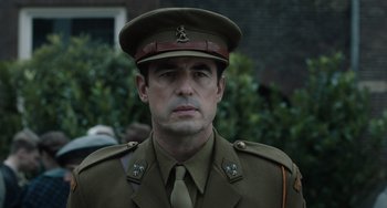 Movie still from “The Last Vermeer” (2019), directed by Dan Friedkin – A person wearing a military uniform; Close Up shot, Low angle