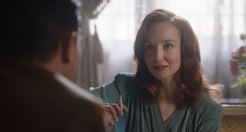 Movie still from “The Last Vermeer” (2019), directed by Dan Friedkin – A woman is talking to a man in front of a mirror; Close Up shot, Over the shoulder angle