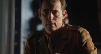 Movie still from “The Last Vermeer” (2019), directed by Dan Friedkin – A person wearing a military uniform; Close Up shot, Low angle