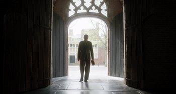 Movie still from “The Last Vermeer” (2019), directed by Dan Friedkin – A man standing in front of an archway in an archway; Wide shot, Low angle