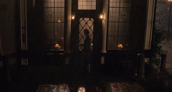 Movie still from “The Last Vermeer” (2019), directed by Dan Friedkin – A person standing in front of a window; Wide shot, Low angle