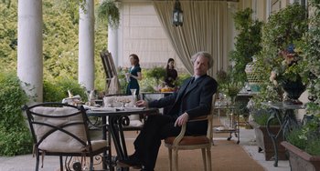 Movie still from “The Last Vermeer” (2019), directed by Dan Friedkin – A man sitting at a table with a plate of food in front of him; Wide shot, Over the shoulder angle