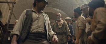 Movie still from “The Last Voyage of the Demeter” (2023), directed by André Øvredal – A group of men standing next to each other in a room; Medium shot, Low angle