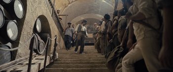 Movie still from “The Last Voyage of the Demeter” (2023), directed by André Øvredal – A group of people standing on some stairs; Wide shot, Low angle
