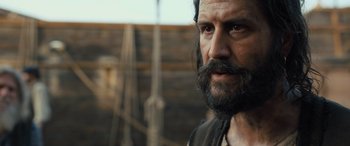 Movie still from “The Last Voyage of the Demeter” (2023), directed by André Øvredal – A person with a beard; Close Up shot, Over the shoulder angle