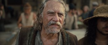 Movie still from “The Last Voyage of the Demeter” (2023), directed by André Øvredal – An old man with long white hair and a beard; Close Up shot, Low angle