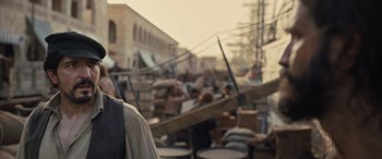 Movie still from “The Last Voyage of the Demeter” (2023), directed by André Øvredal – A group of people walking around in a city area; Medium shot, Over the shoulder angle