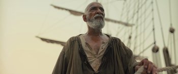 Movie still from “The Last Voyage of the Demeter” (2023), directed by André Øvredal – An old man with a beard and a mustache; Medium shot, Low angle