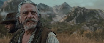 Movie still from “The Last Voyage of the Demeter” (2023), directed by André Øvredal – An old man with a long white beard; Close Up shot, Low angle