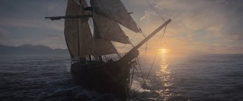 Movie still from “The Last Voyage of the Demeter” (2023), directed by André Øvredal – A sail boat sailing on the ocean at sunset; Extreme Wide shot, Low angle