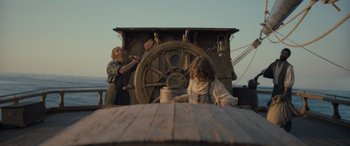 Movie still from “The Last Voyage of the Demeter” (2023), directed by André Øvredal – Two people on a boat in front of a wheel; Wide shot, Low angle