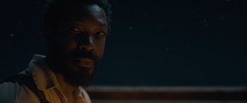 Movie still from “The Last Voyage of the Demeter” (2023), directed by André Øvredal – A person with a beard looking at the camera; Close Up shot, Over the shoulder angle