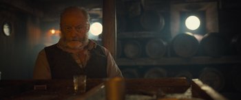 Movie still from “The Last Voyage of the Demeter” (2023), directed by André Øvredal – An older man sitting at a table in front of a mirror; Close Up shot, Over the shoulder angle