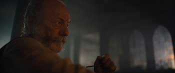 Movie still from “The Last Voyage of the Demeter” (2023), directed by André Øvredal – An older man holding a cigarette in his mouth; Close Up shot, Low angle