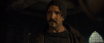 Movie still from “The Last Voyage of the Demeter” (2023), directed by André Øvredal – A person with a beard; Close Up shot, Over the shoulder angle