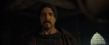 Movie still from “The Last Voyage of the Demeter” (2023), directed by André Øvredal – A person with a beard wearing a hat; Close Up shot, Low angle