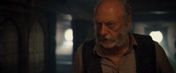 Movie still from “The Last Voyage of the Demeter” (2023), directed by André Øvredal – An old man with a beard and a mustache; Close Up shot, Low angle