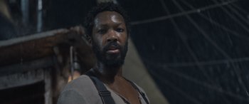 Movie still from “The Last Voyage of the Demeter” (2023), directed by André Øvredal – A man with a beard is looking at the camera; Close Up shot, Low angle